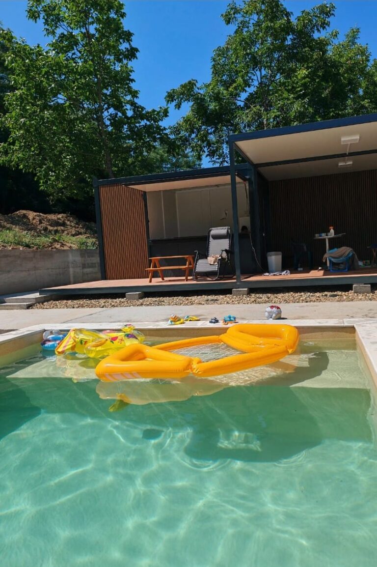 The finished pool with the wooden pavilion behind it